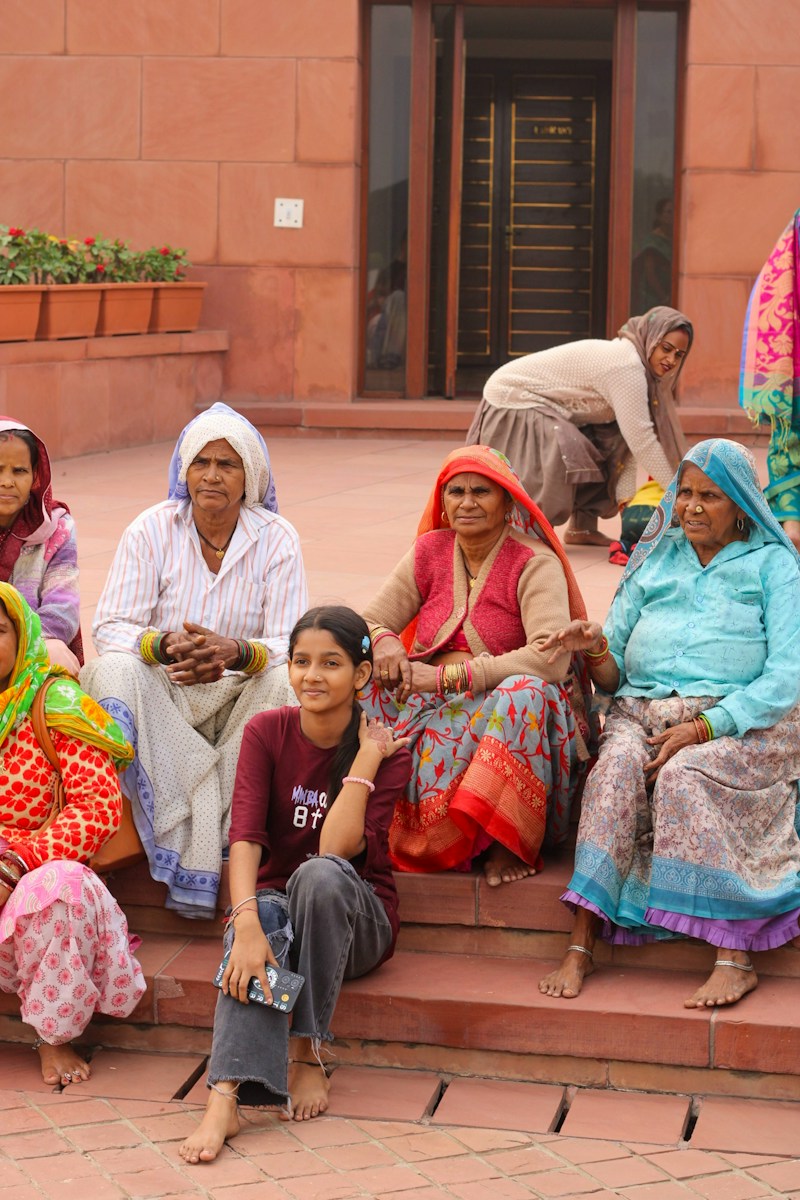 Women of different generations sitting together on stone steps